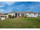 Charming single-story home with manicured lawn, landscaped garden beds, and a welcoming facade at 184 Eppinger Dr, Port Charlotte, FL 33953