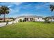Charming single-story home features a well-manicured lawn, lush landscaping, and a welcoming facade at 184 Eppinger Dr, Port Charlotte, FL 33953