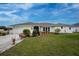 Charming one-story home with a well-manicured lawn and an attached garage, enhanced by colorful landscaping at 184 Eppinger Dr, Port Charlotte, FL 33953