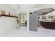 View of the kitchen, dining area and outdoor pool through sliding glass doors at 184 Eppinger Dr, Port Charlotte, FL 33953