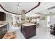 Open kitchen featuring dark wood cabinets, white countertops, a center island and stainless steel appliances at 184 Eppinger Dr, Port Charlotte, FL 33953