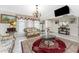 Cozy living room with tile flooring, chandelier, vintage furniture, and large windows at 184 Eppinger Dr, Port Charlotte, FL 33953