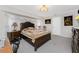 Well-lit main bedroom featuring plush carpet, large windows, and an ornate wooden bed frame at 184 Eppinger Dr, Port Charlotte, FL 33953