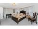 A well lit main bedroom featuring a queen bed, desk, and classic decor at 184 Eppinger Dr, Port Charlotte, FL 33953