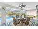 Inviting screened-in patio with dining table and seating, perfect for enjoying the pool view at 184 Eppinger Dr, Port Charlotte, FL 33953