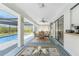 Inviting screened-in patio with dining table and seating, perfect for enjoying the pool view at 184 Eppinger Dr, Port Charlotte, FL 33953
