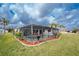Enclosed pool area surrounded by tropical landscaping, offering a private oasis for relaxation and outdoor living at 184 Eppinger Dr, Port Charlotte, FL 33953