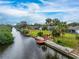 Scenic view of a waterfront property with canal access, lush landscaping, and private dock, perfect for boating enthusiasts at 184 Eppinger Dr, Port Charlotte, FL 33953