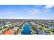 Stunning aerial perspective of a canal-lined community with houses and well-maintained lawns and gardens under blue skies at 2160 Palm Tree Dr, Punta Gorda, FL 33950
