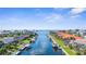 High-angle view capturing a canal-laden community, lined with waterfront homes, docks, and boats under the blue sky at 2160 Palm Tree Dr, Punta Gorda, FL 33950