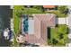Overhead shot of a home with a screened-in pool, boat dock, lush landscaping, and direct water access at 2160 Palm Tree Dr, Punta Gorda, FL 33950
