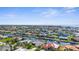 Expansive aerial shot of a waterfront community with lush landscaping and numerous homes lining tranquil canals and waterways at 2160 Palm Tree Dr, Punta Gorda, FL 33950