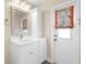 Bathroom features updated vanity with white cabinets and colorful window treatment at 2160 Palm Tree Dr, Punta Gorda, FL 33950
