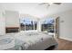 Bright bedroom features wood flooring, fireplace, sliding glass doors, and water view at 2160 Palm Tree Dr, Punta Gorda, FL 33950