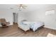 Bedroom boasts wood floors, ceiling fan, and seating area at 2160 Palm Tree Dr, Punta Gorda, FL 33950