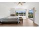 Bright bedroom features wood flooring, sliding glass doors, and water view at 2160 Palm Tree Dr, Punta Gorda, FL 33950