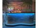 Custom home bar featuring unique aquatic designs and vibrant neon lighting for entertaining at 2160 Palm Tree Dr, Punta Gorda, FL 33950