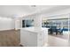 Bright kitchen with white island, stainless appliances, and an open view to the pool area at 2160 Palm Tree Dr, Punta Gorda, FL 33950