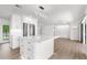 Bright kitchen with white cabinets, island, stainless steel appliances and sliding doors to the outside at 2160 Palm Tree Dr, Punta Gorda, FL 33950