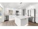 Modern kitchen with stainless steel appliances, an island, and white cabinets at 2160 Palm Tree Dr, Punta Gorda, FL 33950