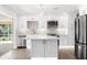 Modern kitchen featuring white cabinetry, stainless steel appliances, and a functional center island at 2160 Palm Tree Dr, Punta Gorda, FL 33950
