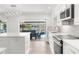 Well-lit kitchen with white cabinets, modern appliances, and an inviting view of the pool at 2160 Palm Tree Dr, Punta Gorda, FL 33950