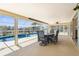 Enclosed lanai with table and chairs overlooking the sparkling pool and waterfront views at 2160 Palm Tree Dr, Punta Gorda, FL 33950