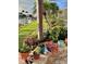 Landscaped backyard featuring a canal view, dock, flowering beds, and mature palm trees at 2160 Palm Tree Dr, Punta Gorda, FL 33950