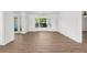 Bright living room showcasing light wood flooring, large window, and white trim throughout at 2160 Palm Tree Dr, Punta Gorda, FL 33950