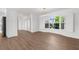Bright living room featuring light wood flooring and a large window with natural light at 2160 Palm Tree Dr, Punta Gorda, FL 33950