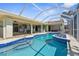 This home features a gorgeous pool and patio with an attached spa and lanai at 2160 Palm Tree Dr, Punta Gorda, FL 33950
