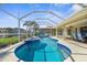 Picture of the sparkling pool and spa with screened-in enclosure and outdoor seating area at 2160 Palm Tree Dr, Punta Gorda, FL 33950