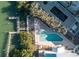 Gorgeous aerial view of community pool with lounge chairs, and a waterway with dockage at 2255 N Beach Rd # 13, Englewood, FL 34223