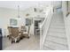 Bright dining room with staircase and passthrough to the kitchen at 2255 N Beach Rd # 13, Englewood, FL 34223