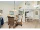Charming dining room with a glass table, wicker chairs, and an open view to the kitchen at 2255 N Beach Rd # 13, Englewood, FL 34223