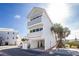 Exterior of a white beach condo with well-maintained grounds and parking at 2255 N Beach Rd # 13, Englewood, FL 34223