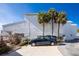 A beautiful building featuring a driveway and palm trees at 2255 N Beach Rd # 13, Englewood, FL 34223