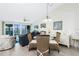 Bright and airy living area with coastal decor, dining table, and balcony access at 2255 N Beach Rd # 13, Englewood, FL 34223