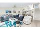 Bright and airy living room with comfortable seating, stairs, and stylish decor at 2255 N Beach Rd # 13, Englewood, FL 34223