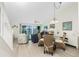 Open-concept living and dining area with sliding glass doors leading to the balcony at 2255 N Beach Rd # 13, Englewood, FL 34223