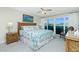 Bright primary bedroom with ample natural light and sliding glass doors to a balcony at 2255 N Beach Rd # 13, Englewood, FL 34223