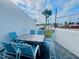 Outdoor patio featuring table and chairs with a view of a palm tree and the street at 2255 N Beach Rd # 13, Englewood, FL 34223