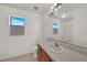 Bathroom featuring wood cabinets, mirror, and a bright window at 2495 De Garmo St, North Port, FL 34291