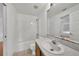 Bathroom with a shower and tub combo, wood cabinet, and tile floor at 2495 De Garmo St, North Port, FL 34291
