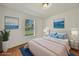 Bright bedroom featuring hardwood floors, a plush bed, and calming wall art at 2495 De Garmo St, North Port, FL 34291