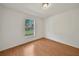 This bedroom has wood-look laminate flooring and a large sunny window at 2495 De Garmo St, North Port, FL 34291