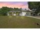 Charming single-story home featuring a well-maintained lawn and attached two car garage at 2495 De Garmo St, North Port, FL 34291