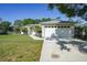 Charming single-story home with an attached garage and manicured lawn at 2495 De Garmo St, North Port, FL 34291