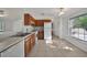 Functional kitchen with white appliances, laminate countertops, and a sun-filled dining area at 2495 De Garmo St, North Port, FL 34291