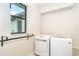 Bright laundry room with front-load washer and dryer at 25583 Prada Dr, Punta Gorda, FL 33955